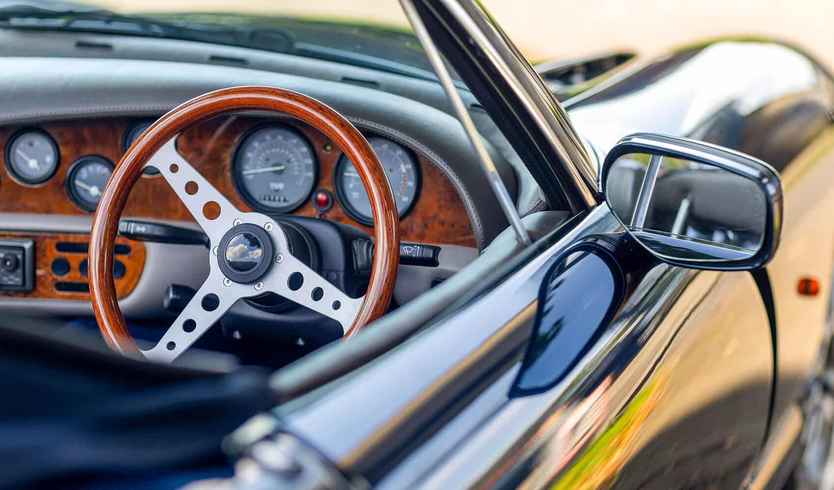 A view into the driver's side window of a British sports car