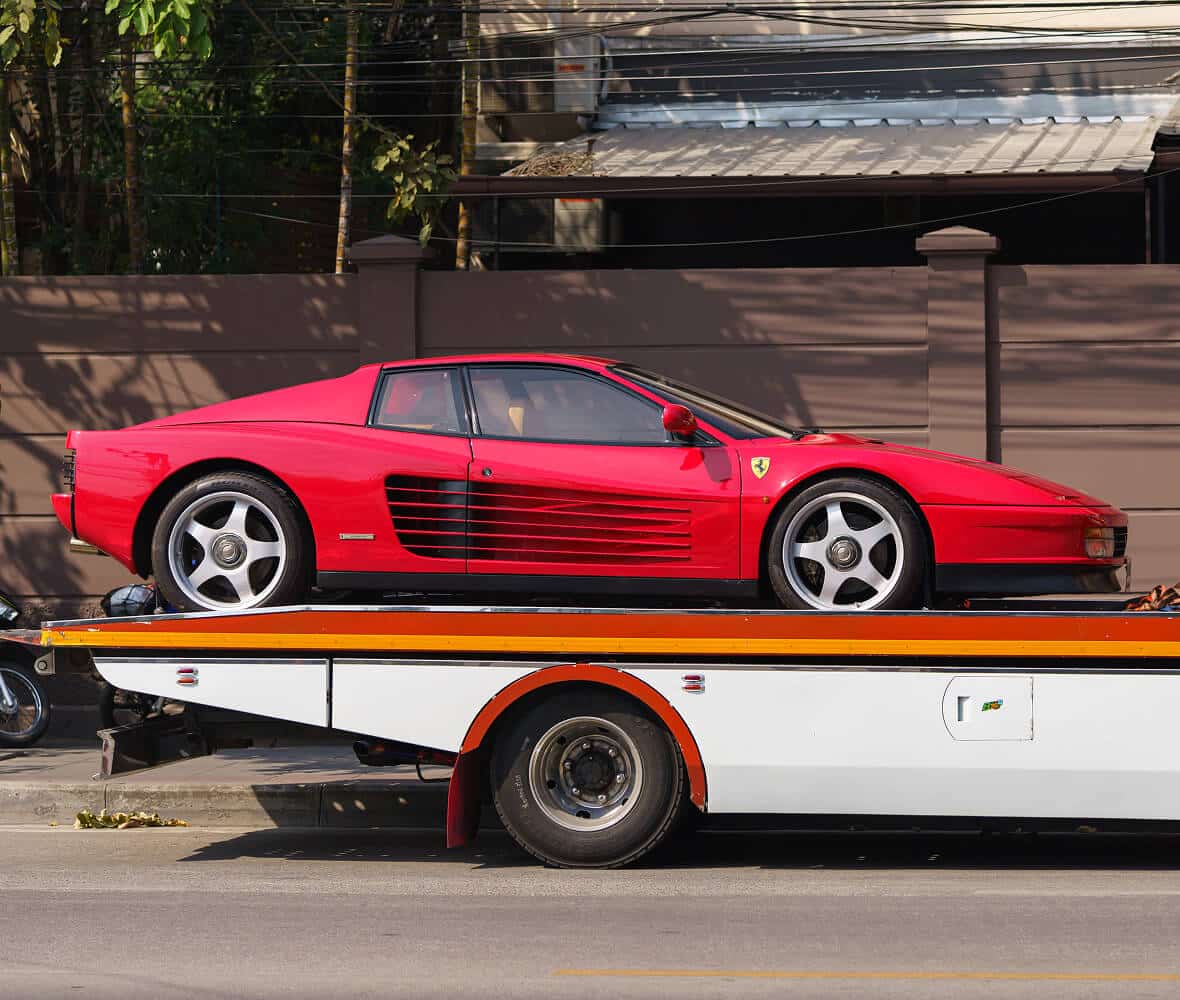 A red sports car on a flatbed truck
