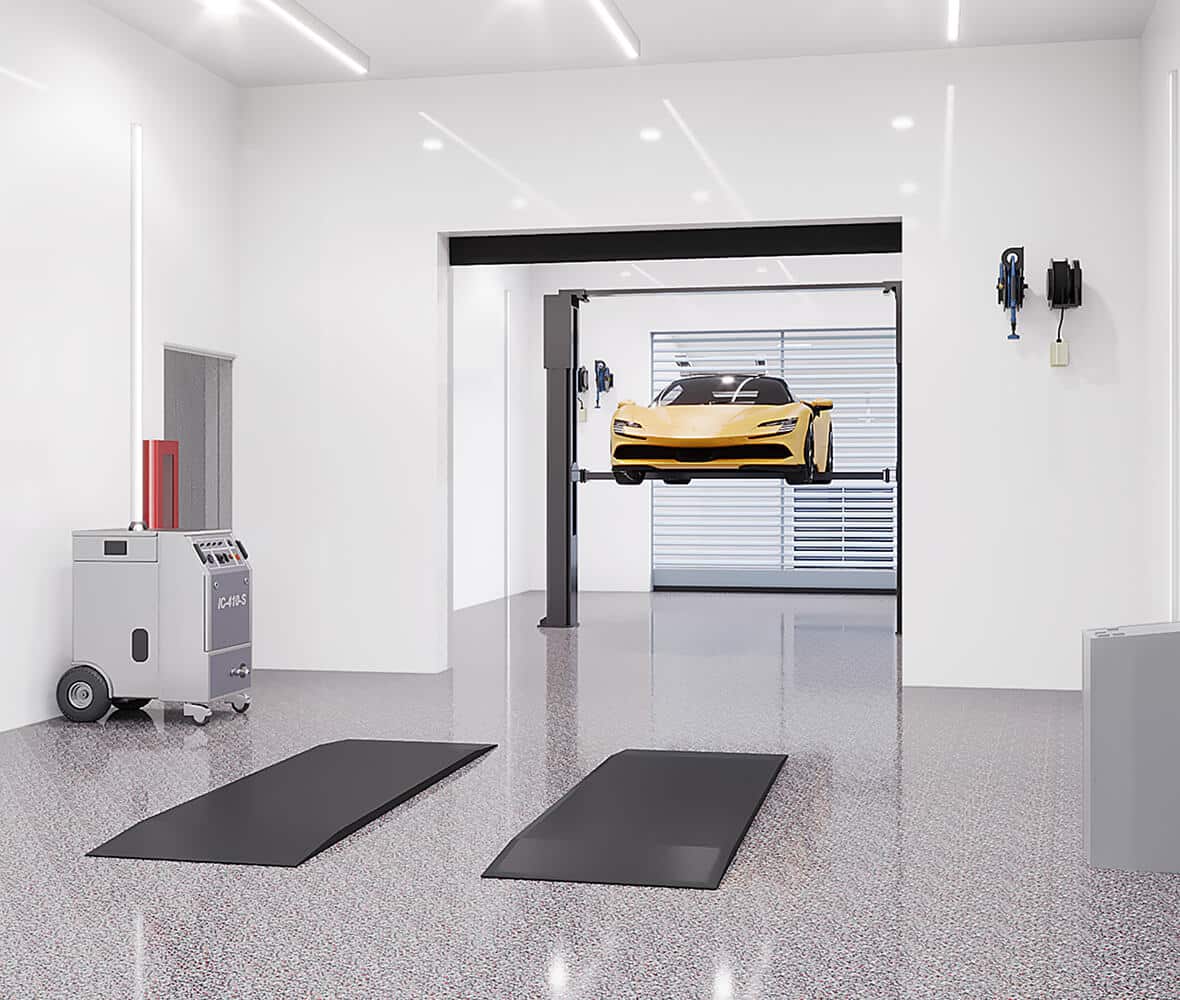 A sports car on a lift in a climate controlled storage garage